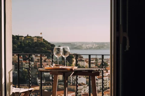 Savor wines and tapas with views of the St George Castle and the Tagus
