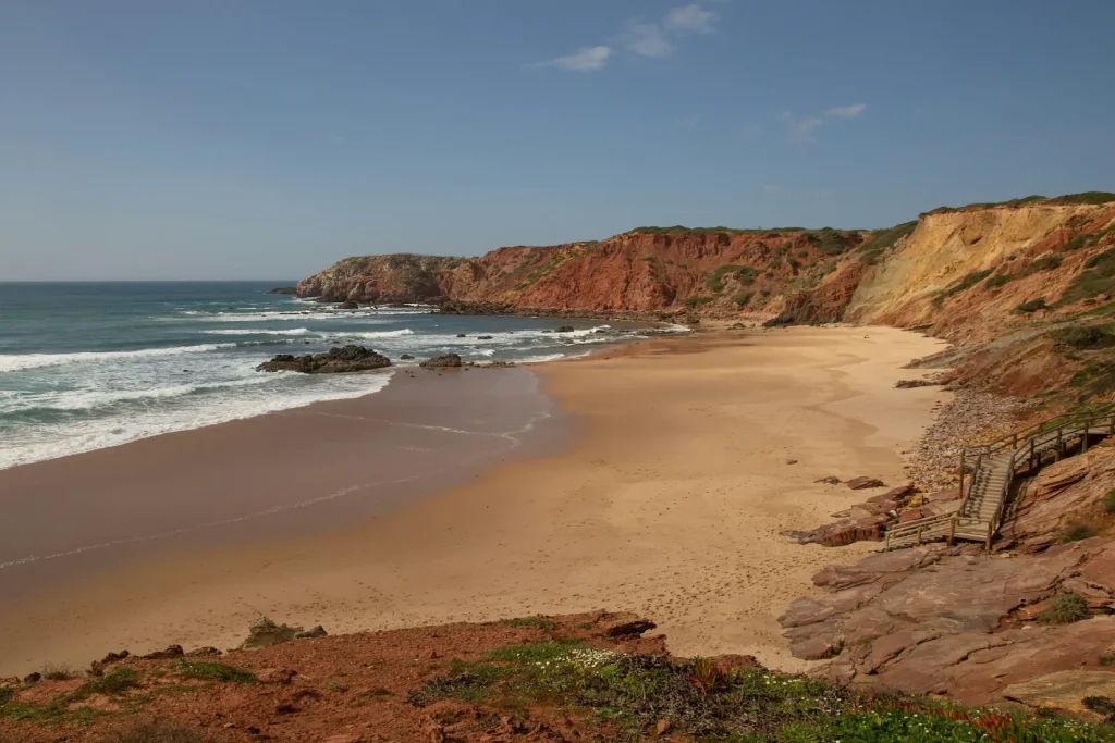 Coast of Portugal – admire the tones between red and blue rocks of the ocean